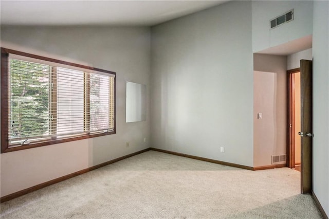 562 Pine Valley Rd SE, Marietta, GA 30067 - spare room featuring carpet flooring and high vaulted ceiling