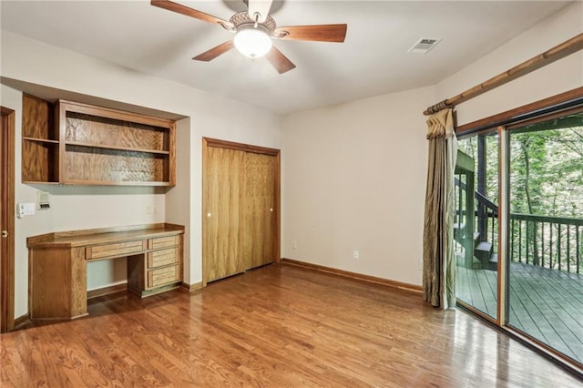 562 Pine Valley Rd SE, Marietta, GA 30067 - unfurnished living room featuring built in study area, wood finished floors, and a ceiling fan