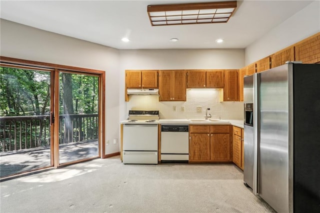 562 Pine Valley Rd SE, Marietta, GA 30067 - kitchen with white appliances, brown cabinets, under cabinet range hood, light colored carpet, and light countertops