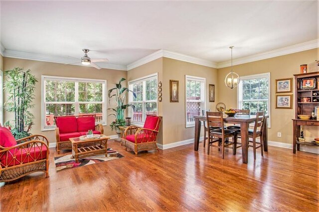 dining space featuring hardwood / wood-style floors, a healthy amount of sunlight, and ornamental molding