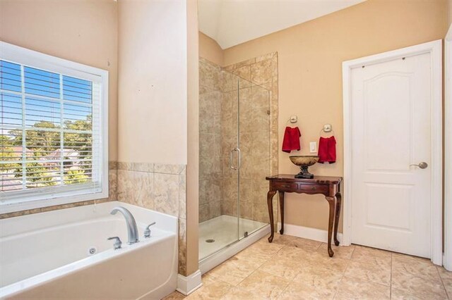 bathroom with plus walk in shower and tile patterned flooring