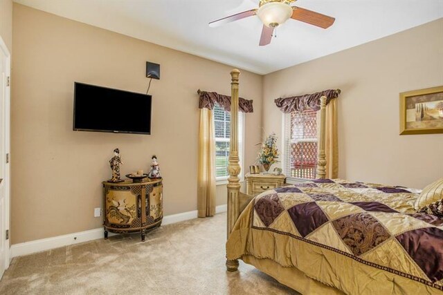 bedroom with light colored carpet and ceiling fan