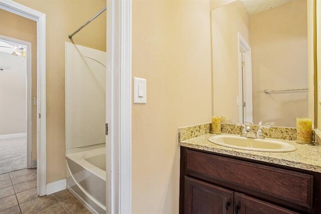 bathroom with tile patterned flooring, vanity, and shower / washtub combination