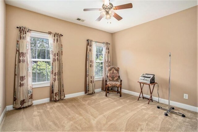 unfurnished room with ceiling fan and light carpet