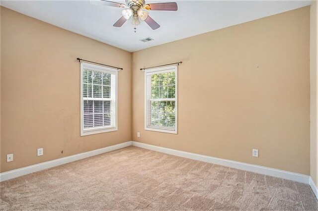 empty room with light carpet and ceiling fan