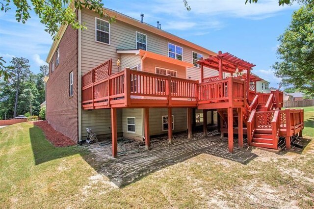 rear view of property with a yard, a pergola, and a wooden deck