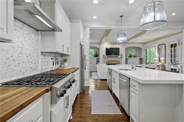 3075 Woodvale Ct, Alpharetta, GA 30022 - kitchen with wall chimney exhaust hood, wood counters, open floor plan, appliances with stainless steel finishes, and recessed lighting