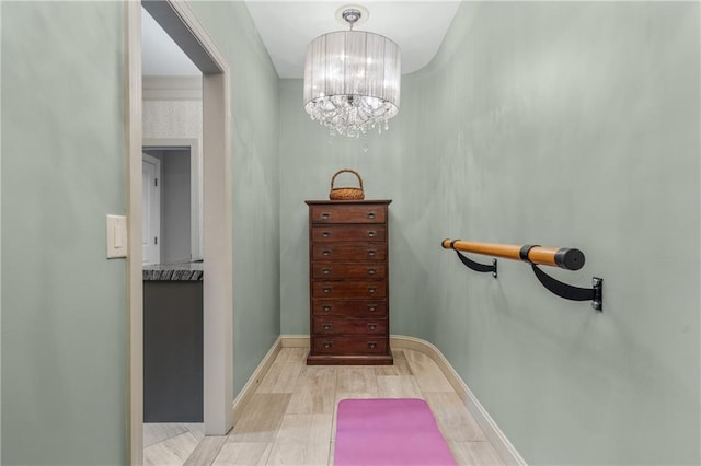3075 Woodvale Ct, Alpharetta, GA 30022 - corridor with light wood finished floors, a chandelier, and baseboards
