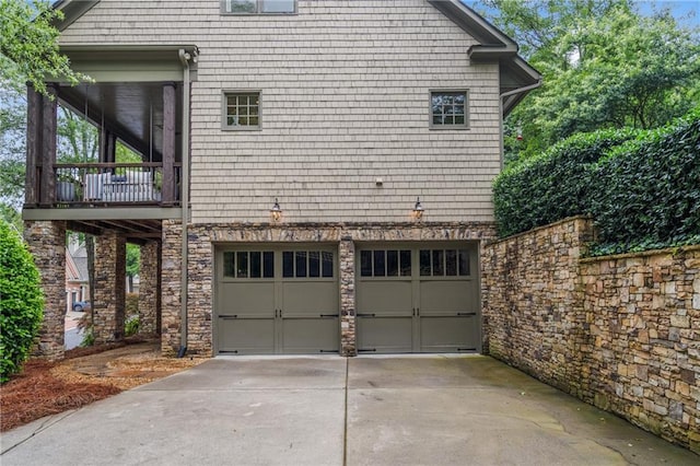 3075 Woodvale Ct, Alpharetta, GA 30022 - view of side of property with driveway, a garage, and stone siding