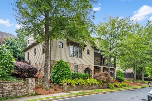 3075 Woodvale Ct, Alpharetta, GA 30022 - view of front of house with stone siding and a balcony