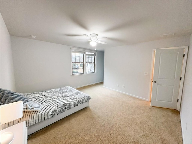 bedroom featuring light carpet, ceiling fan, and baseboards