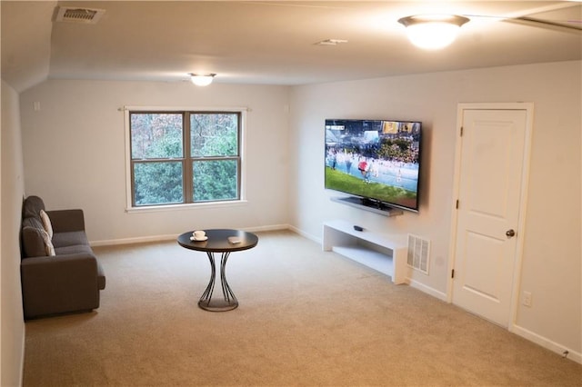 living room featuring light colored carpet and vaulted ceiling