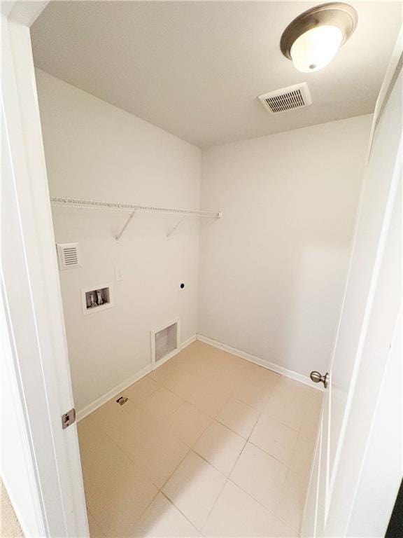 laundry area with laundry area, hookup for a washing machine, visible vents, and baseboards