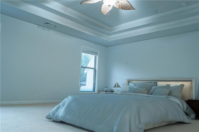 carpeted bedroom with ornamental molding, a raised ceiling, visible vents, and baseboards