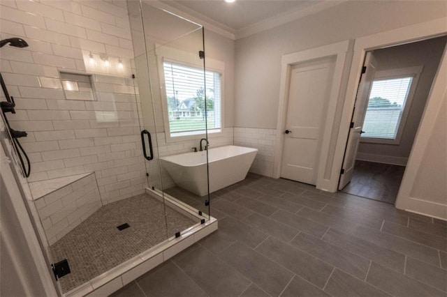 bathroom featuring tile walls, tile patterned floors, ornamental molding, and shower with separate bathtub