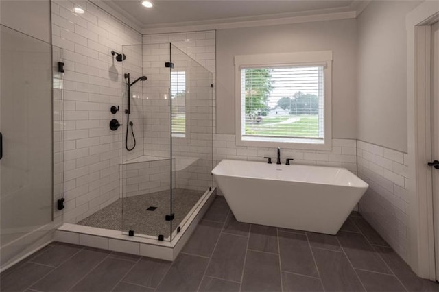 bathroom with tile walls, tile patterned floors, independent shower and bath, and ornamental molding