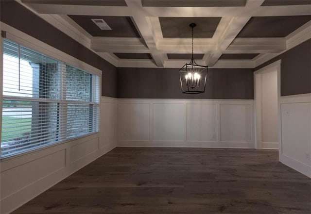 unfurnished dining area with dark wood-type flooring, a notable chandelier, and coffered ceiling