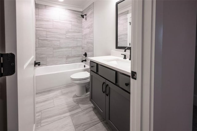 full bathroom with toilet, tiled shower / bath, and vanity