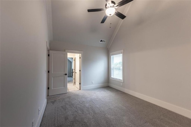 spare room with ceiling fan, carpet flooring, and high vaulted ceiling