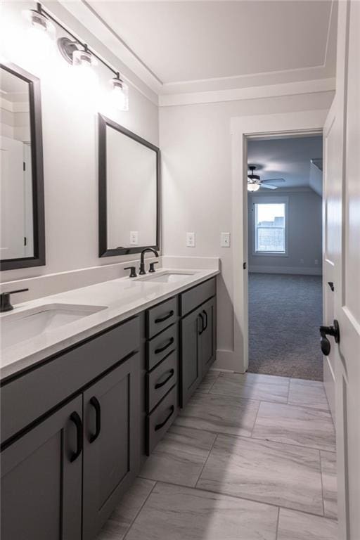 bathroom featuring ceiling fan, crown molding, and vanity