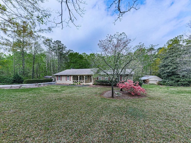 ranch-style house featuring a porch and a front yard