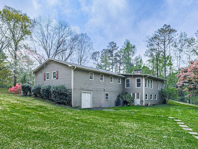 rear view of house with a yard