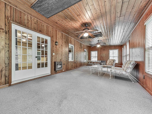 unfurnished sunroom with wood ceiling, ceiling fan, and heating unit