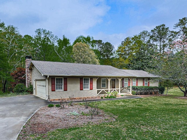 single story home with a porch, a garage, and a front lawn