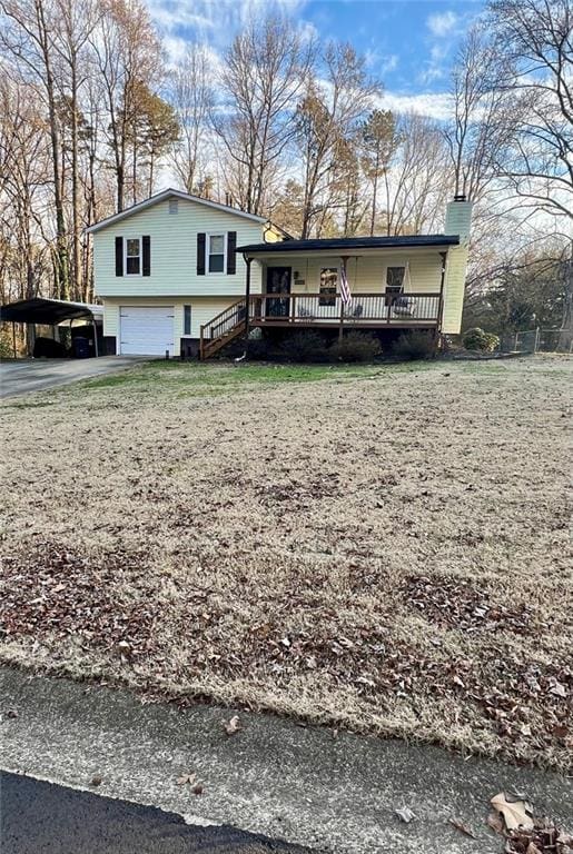 tri-level home featuring a garage and covered porch