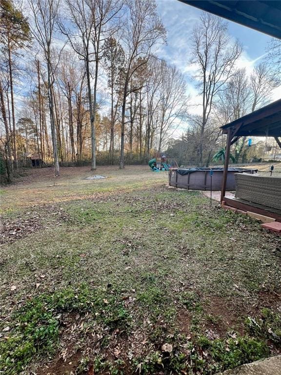 view of yard featuring a covered pool