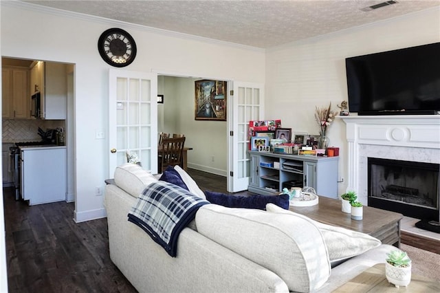 living room featuring a textured ceiling, dark hardwood / wood-style floors, crown molding, and a premium fireplace