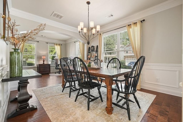 4003 Coachman Ct, Cumming, GA 30040 - dining space featuring arched walkways, ornamental molding, healthy amount of natural light, a chandelier, and wainscoting
