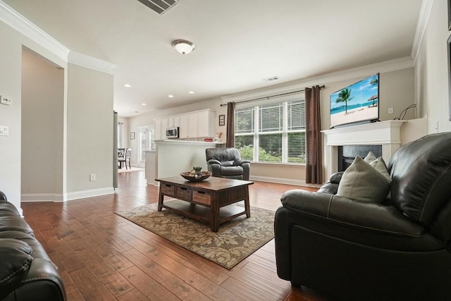 4003 Coachman Ct, Cumming, GA 30040 - living room featuring recessed lighting, wood-type flooring, ornamental molding, and a fireplace