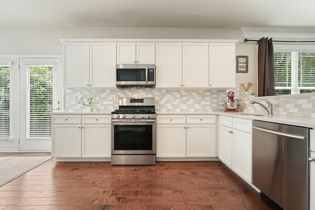 4003 Coachman Ct, Cumming, GA 30040 - kitchen featuring appliances with stainless steel finishes, healthy amount of natural light, light countertops, and decorative backsplash