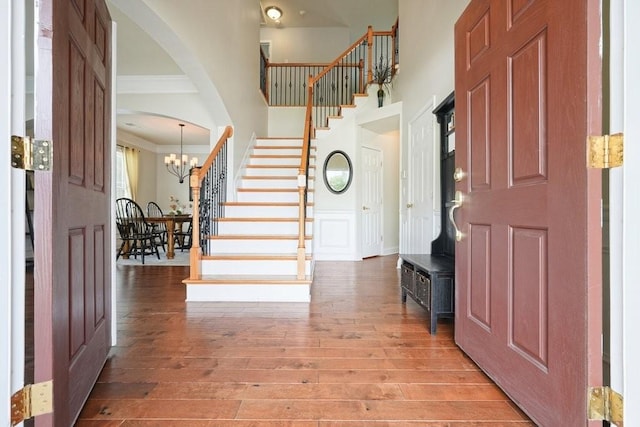4003 Coachman Ct, Cumming, GA 30040 - entrance foyer with stairway, light wood finished floors, ornamental molding, a chandelier, and a high ceiling