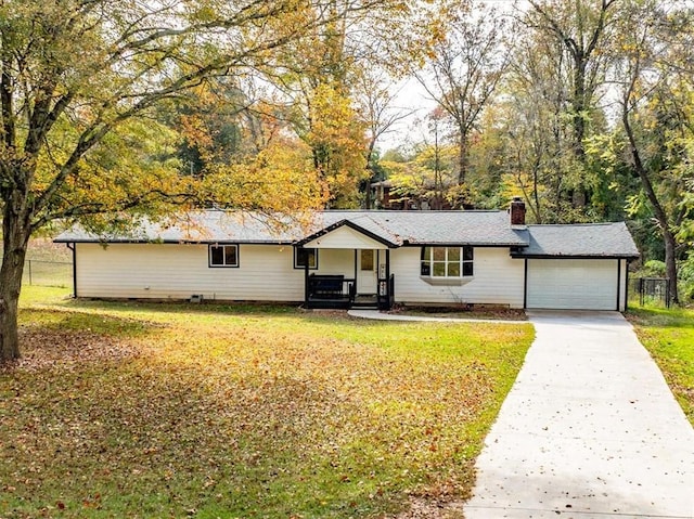 ranch-style home with a garage and a front lawn