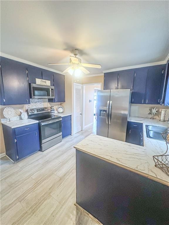 kitchen featuring sink, ceiling fan, appliances with stainless steel finishes, ornamental molding, and light hardwood / wood-style floors