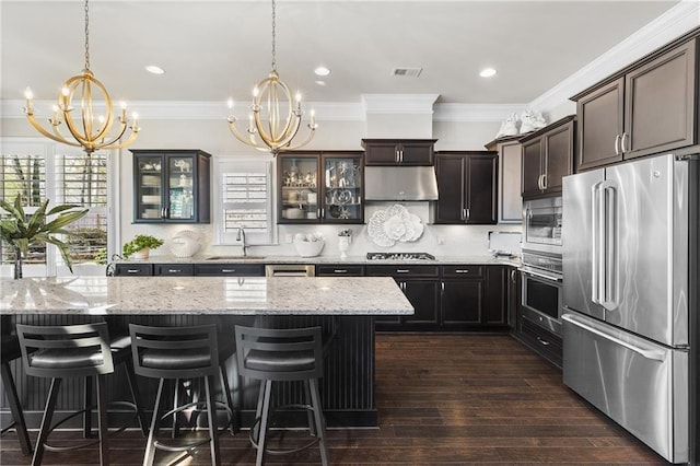 1250 Atherton Park, Roswell, GA 30076 - kitchen featuring stainless steel appliances, a chandelier, glass insert cabinets, a sink, and light stone counters