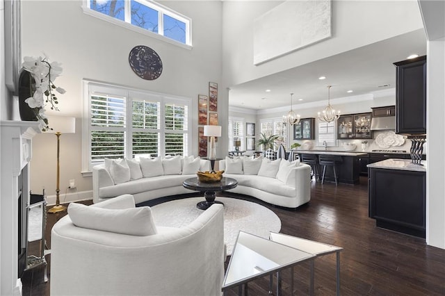 1250 Atherton Park, Roswell, GA 30076 - living room with a chandelier, dark wood-type flooring, crown molding, recessed lighting, and a high ceiling