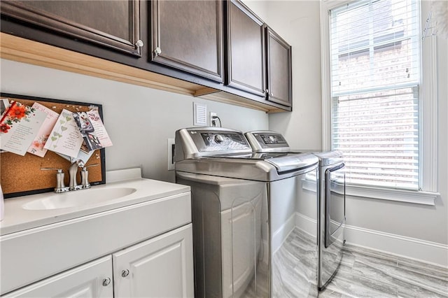 1250 Atherton Park, Roswell, GA 30076 - laundry area featuring washer and dryer, cabinet space, baseboards, and light wood-style flooring