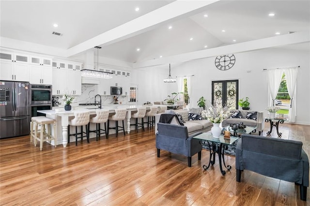 living area with recessed lighting, a wealth of natural light, and light wood-type flooring
