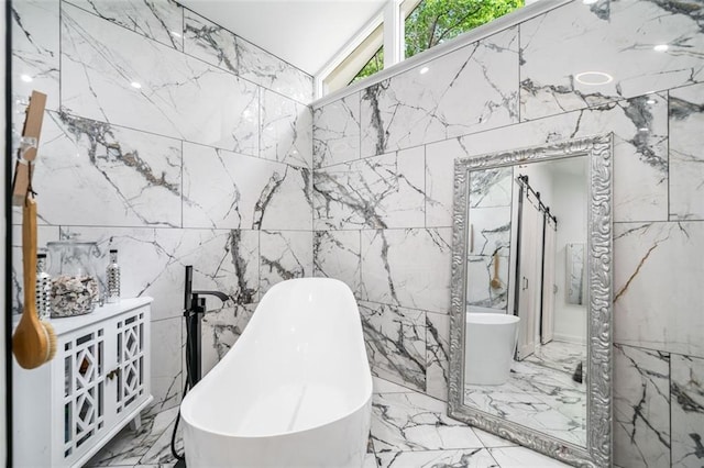 full bath with tile walls, marble finish floor, and a freestanding bath