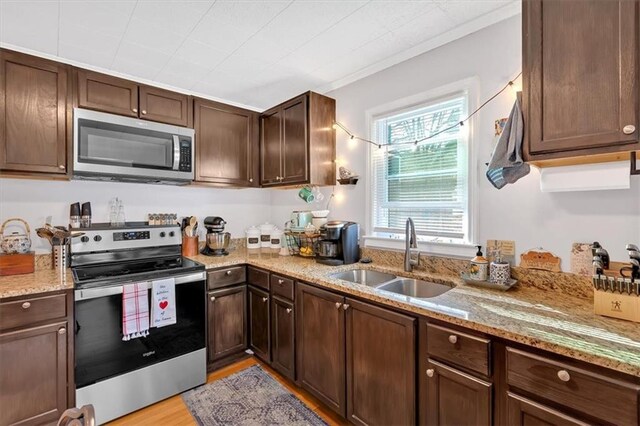 dining space with light wood finished floors, baseboards, and crown molding