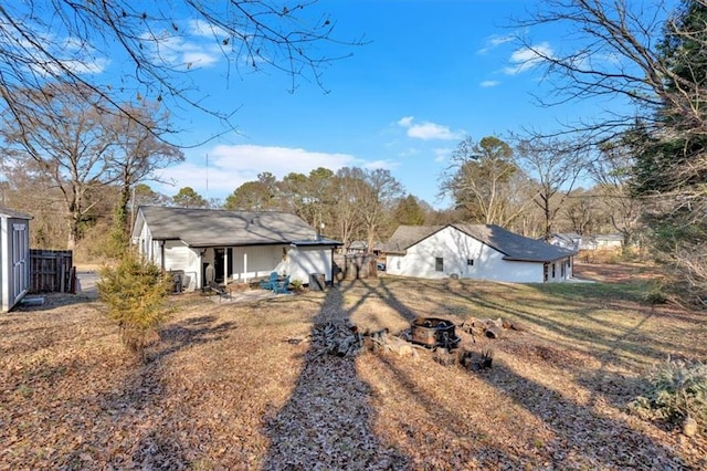 view of yard with an outdoor fire pit and fence