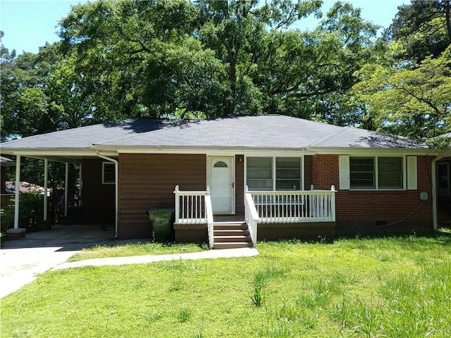 732 Vinson Pl SW, Atlanta, GA 30315 - view of front of house with covered porch, driveway, a front lawn, a carport, and brick siding