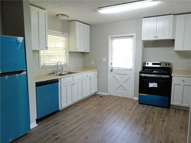 732 Vinson Pl SW, Atlanta, GA 30315 - kitchen with freestanding refrigerator, electric stove, dishwasher, a sink, and wood finished floors
