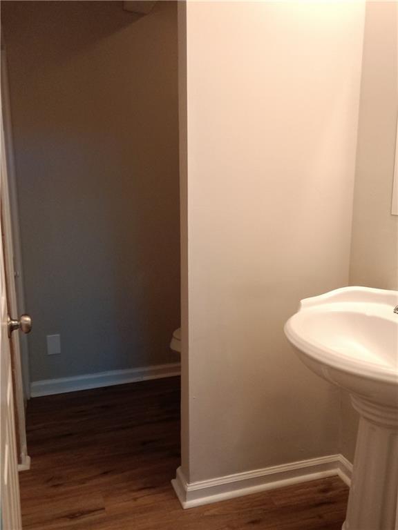732 Vinson Pl SW, Atlanta, GA 30315 - half bath featuring wood finished floors and baseboards