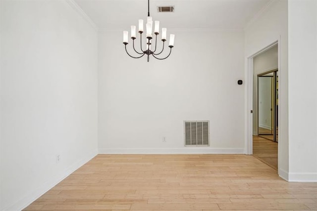 2921 Lenox Rd Unit 308, Atlanta, GA 30324 - spare room featuring a chandelier, light wood finished floors, ornamental molding, and baseboards