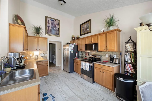 102 Autumn Brooke Trl, Dallas, GA 30157 - kitchen with appliances with stainless steel finishes, a sink, light countertops, decorative backsplash, and light marble finish flooring