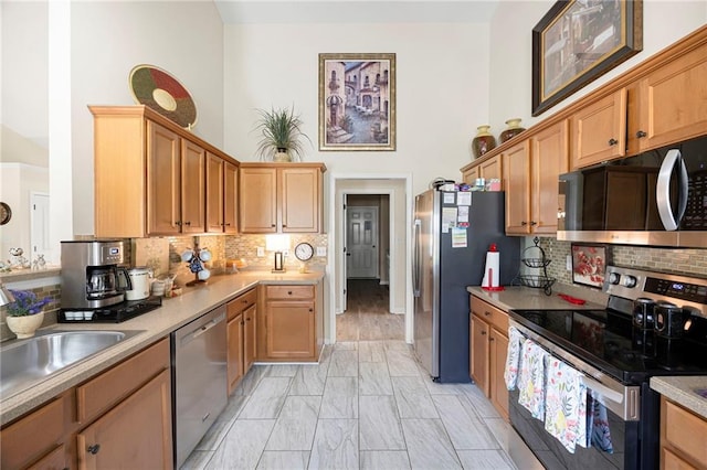 102 Autumn Brooke Trl, Dallas, GA 30157 - kitchen with appliances with stainless steel finishes, decorative backsplash, light marble finish floors, a towering ceiling, and light countertops